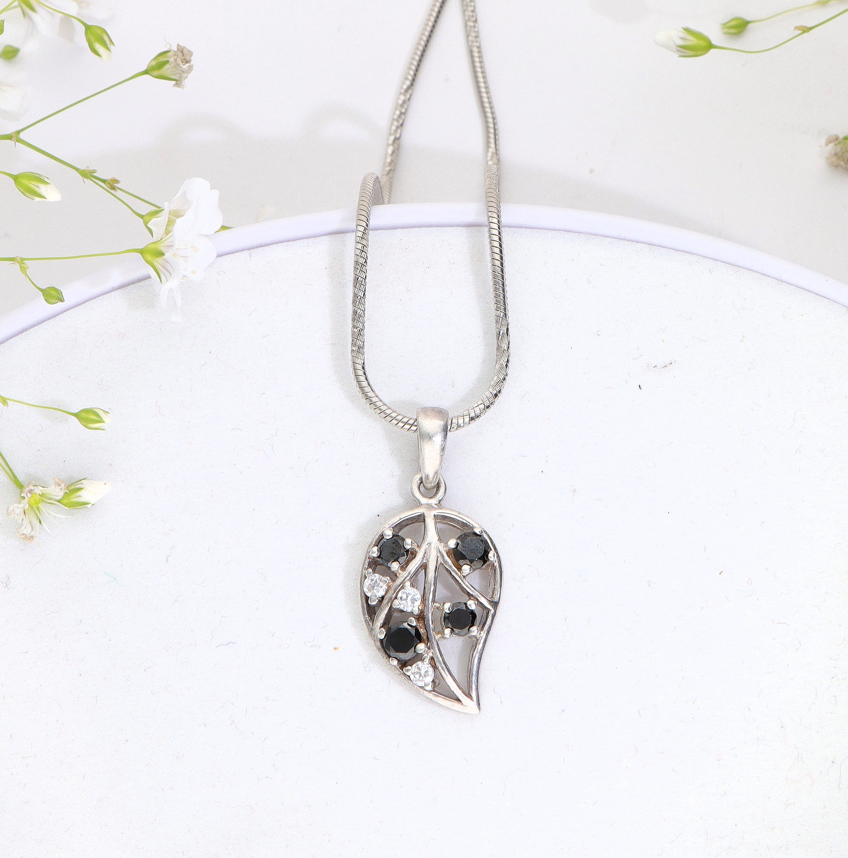 Enchanting black stone embossed silver leaf pendant