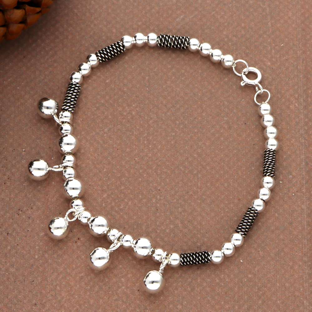 Metal ball inspired silver bracelet with dangling charms