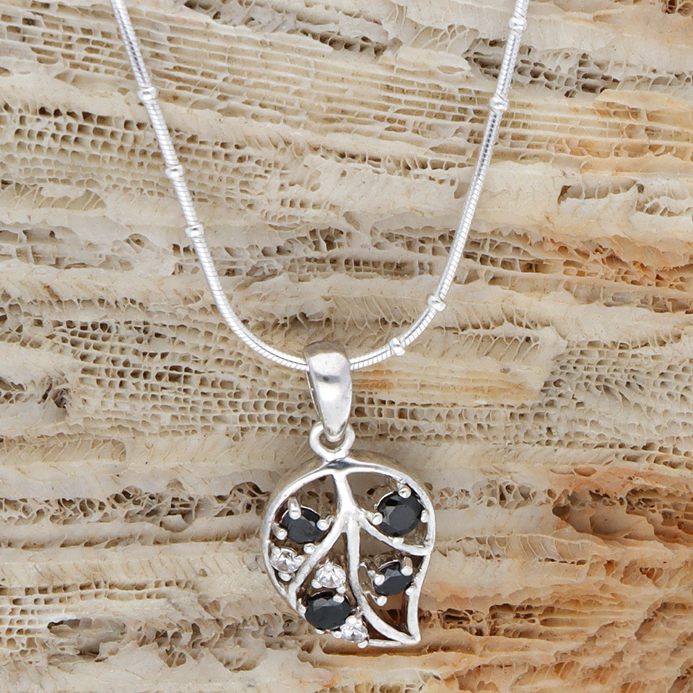 Enchanting black stone embossed silver leaf pendant